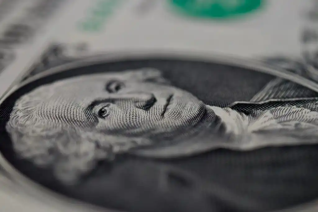 Close-up view of George Washington’s portrait on a U.S. one dollar bill, with fine details of the engraving clearly visible and parts of the bill slightly out of focus.