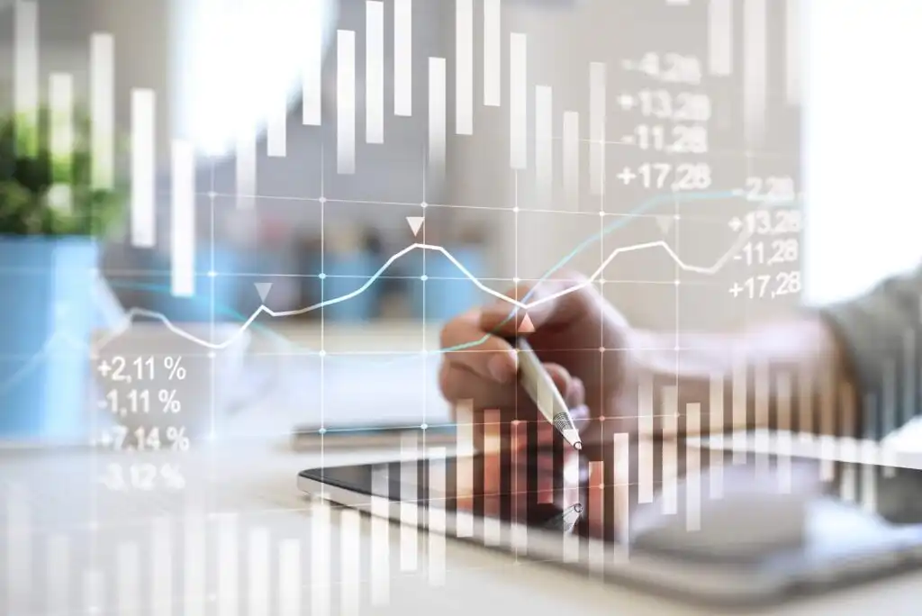 A person uses a stylus on a tablet, with financial graphs, charts, and data percentages overlaid, representing analysis or trading in a modern, digital workspace.